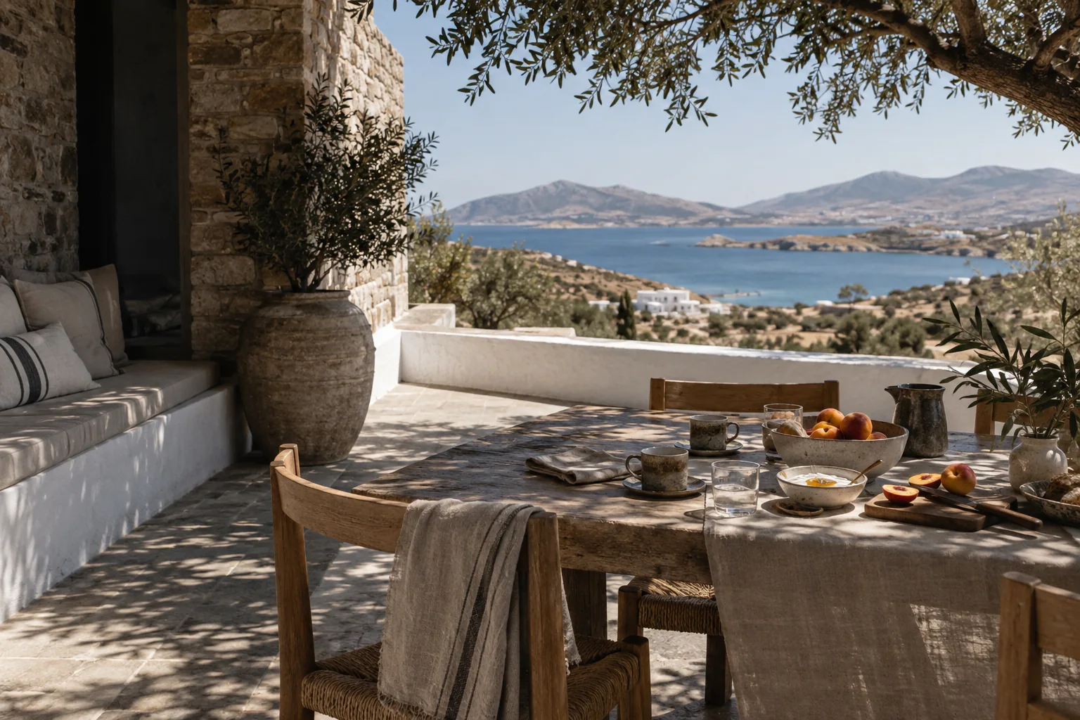 Breakfast laid on a shaded private villa terrace above the Aegean